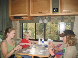 Chelsi, Nathan, and Nick playing cards in the RV